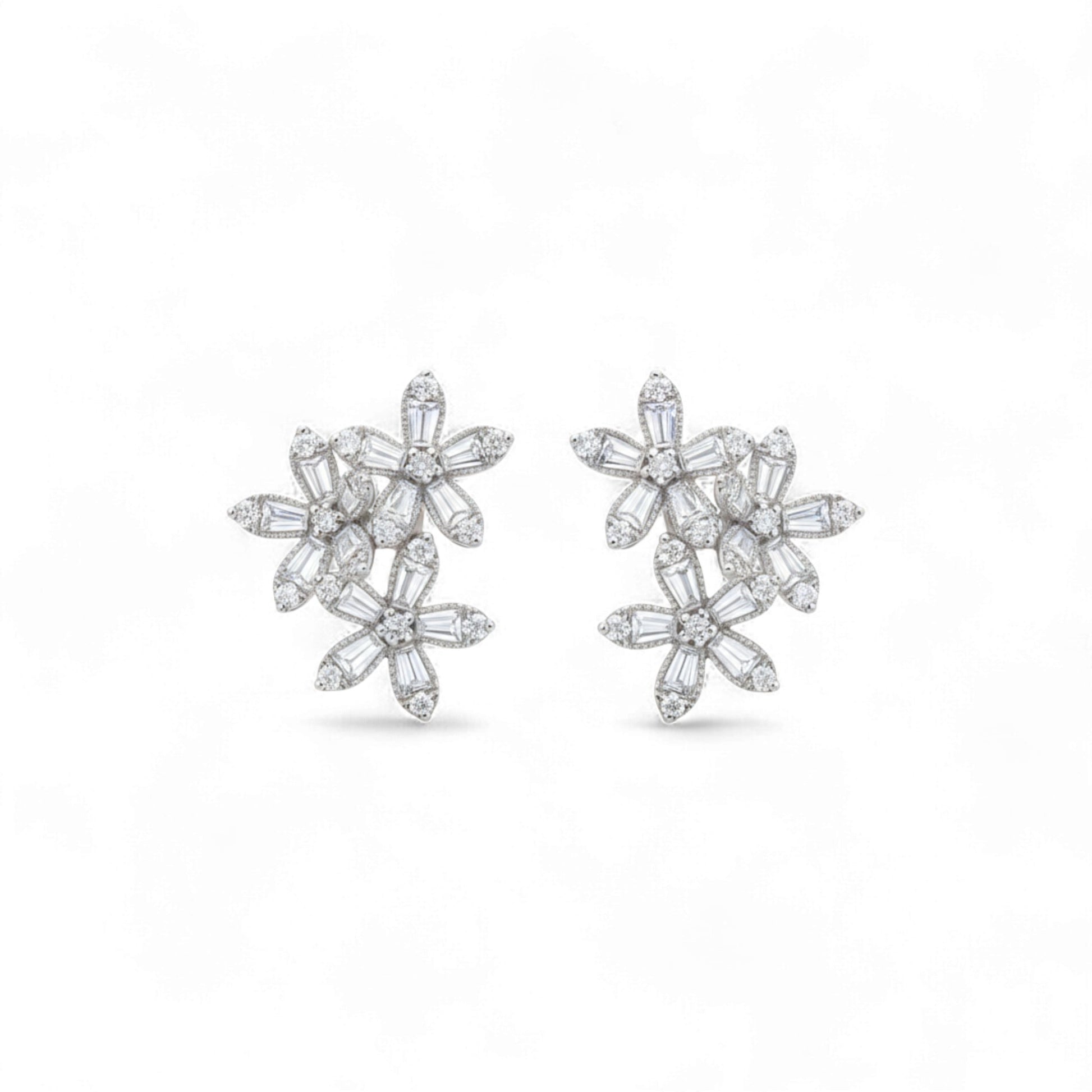 Pair of diamond flower earrings on a white background