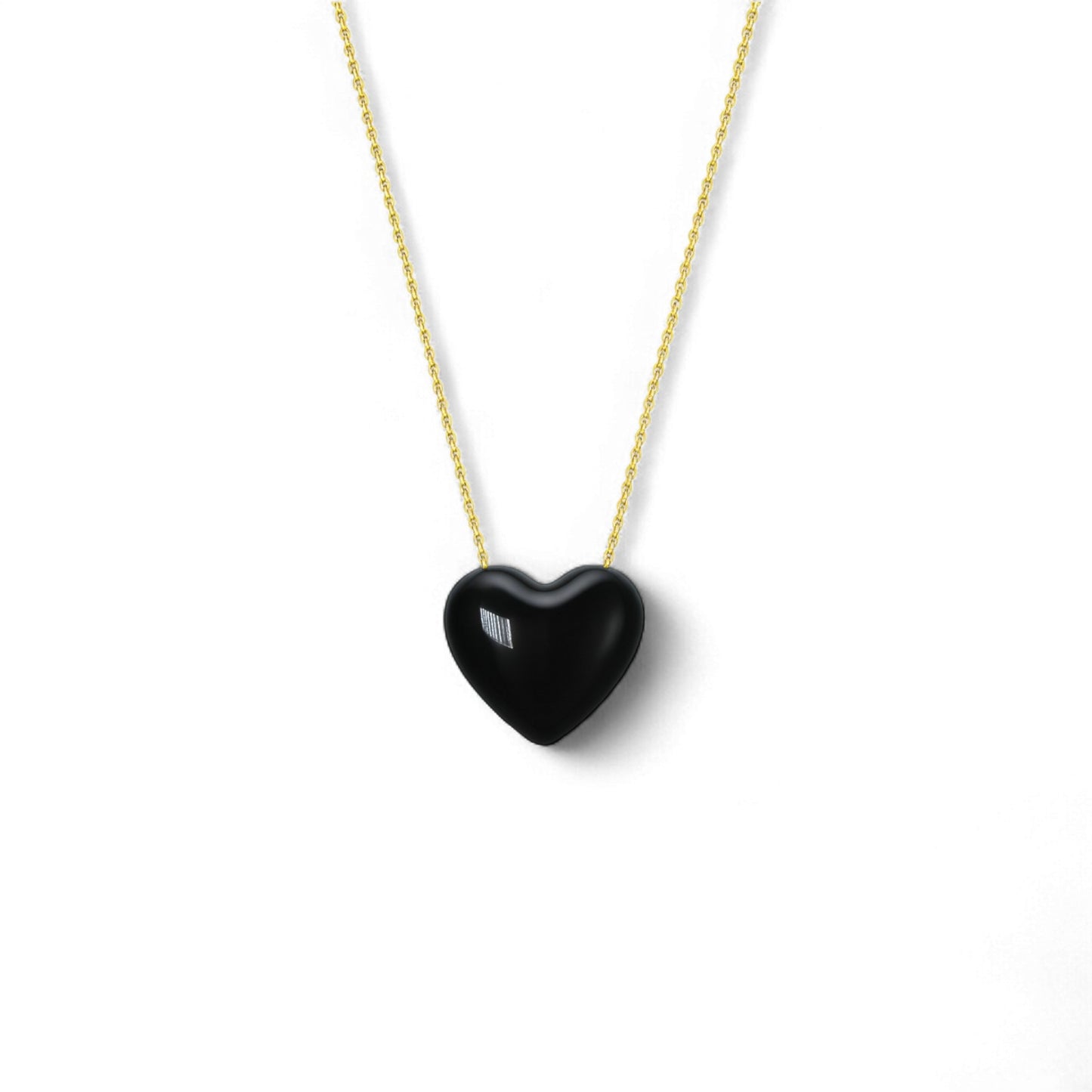 Black heart-shaped pendant on a gold chain against a white background