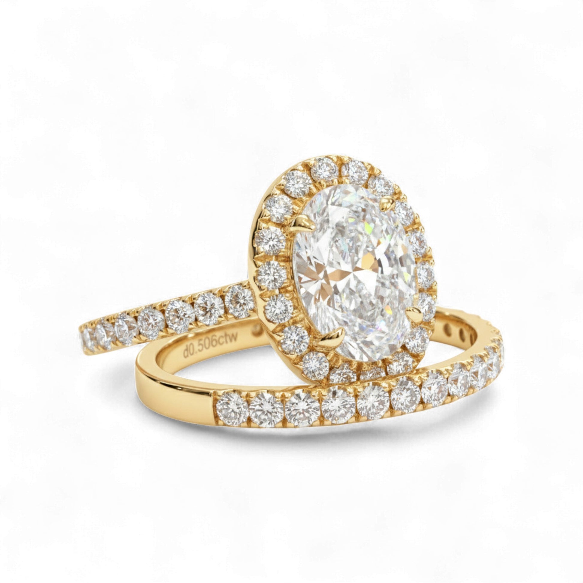 Gold ring with a large diamond and smaller diamonds on a white background