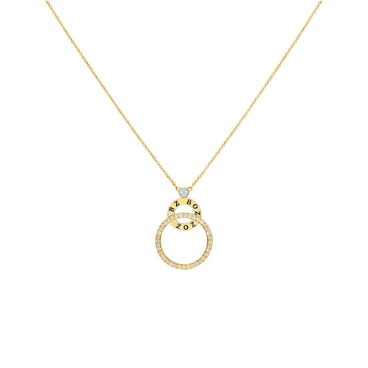 Gold necklace with a circular pendant on a white background