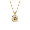 Gold necklace with a round pendant featuring a face design on a white background