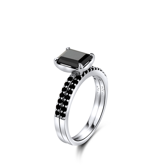 Silver ring with a black gemstone on a white background
