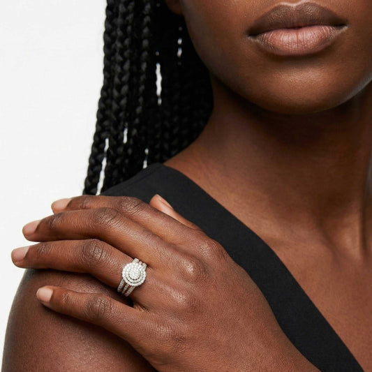Close-up of a woman's hand wearing a ring with a white background