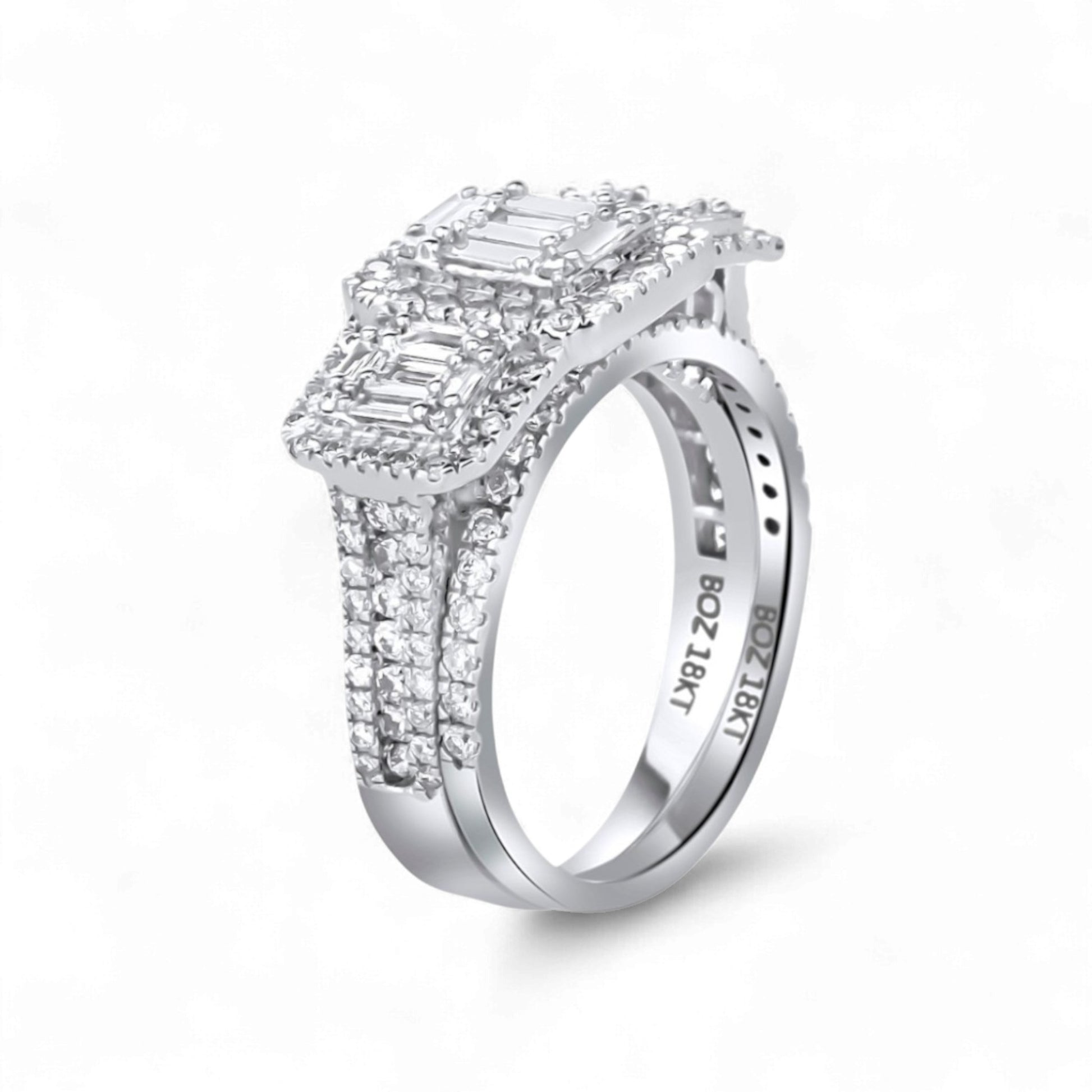 Diamond ring with emerald-cut center stone on a white background