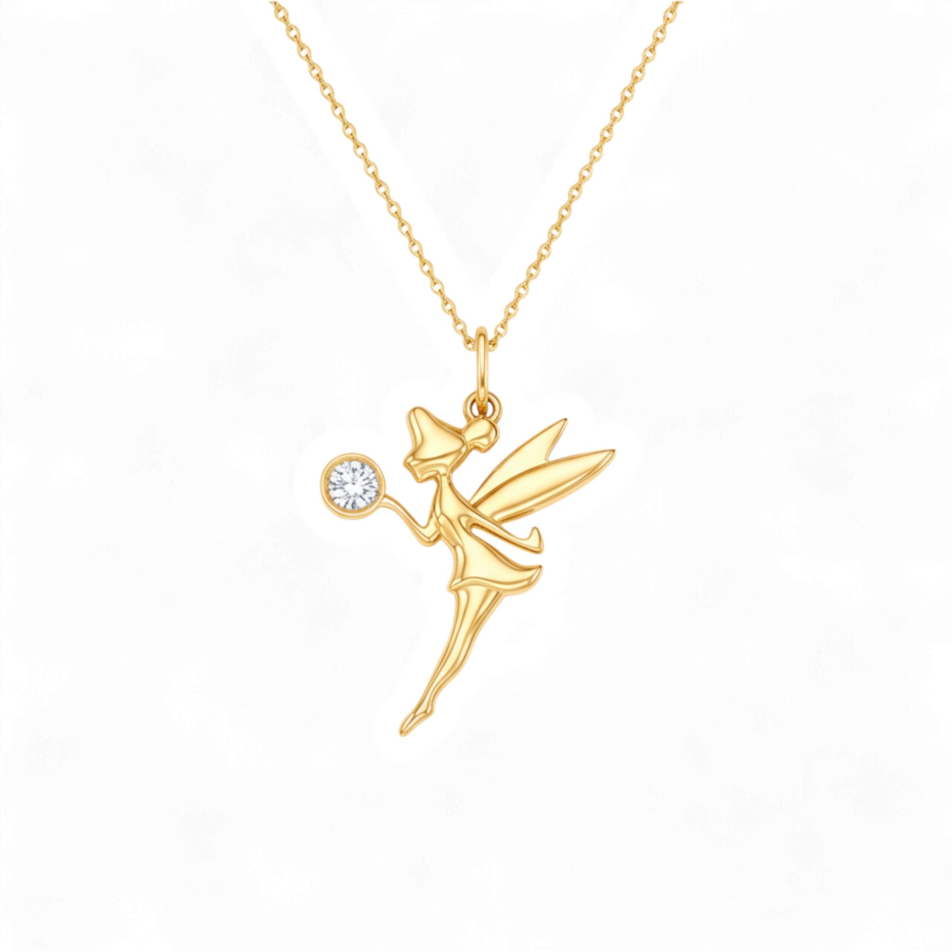 Gold fairy pendant necklace on a white background