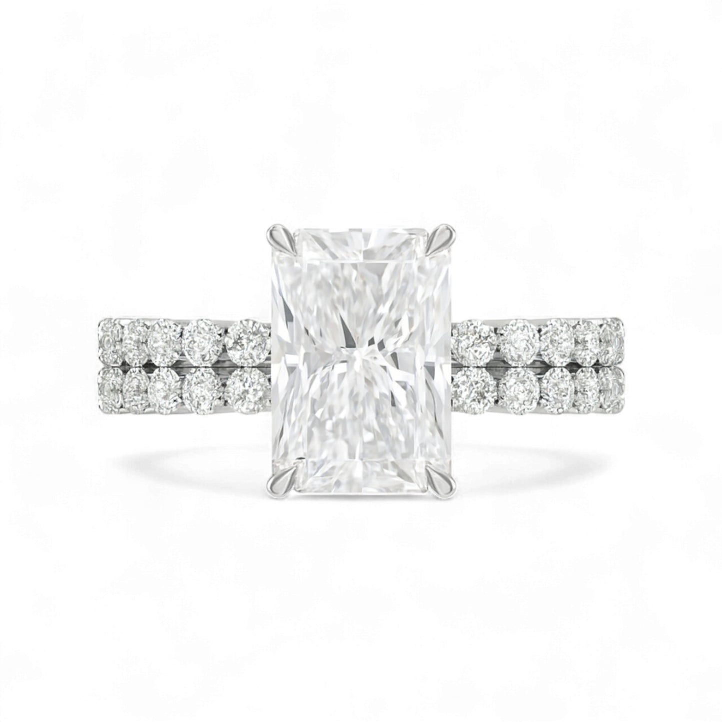 Diamond ring with a rectangular center stone on a white background