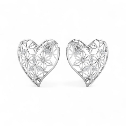 Heart-shaped silver earrings with intricate designs on a white background