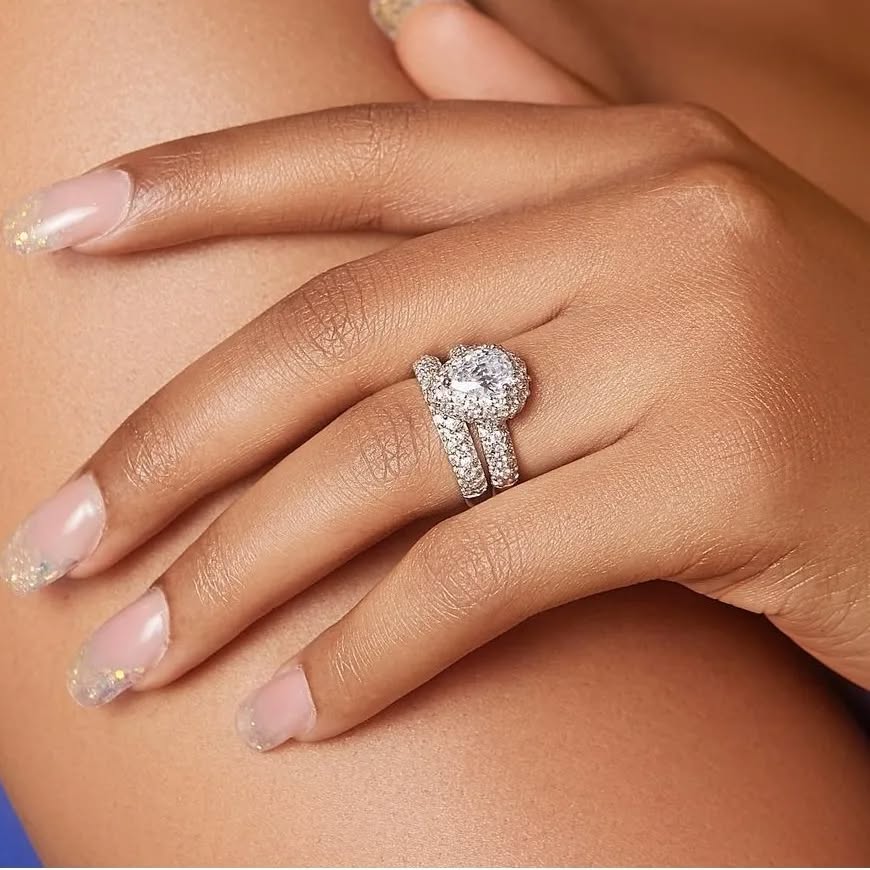 A woman's hand displaying a pear-cut cubic zirconia ring set in 925 sterling silver.