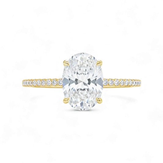 Gold ring with a large central diamond and smaller diamonds on the band against a white background