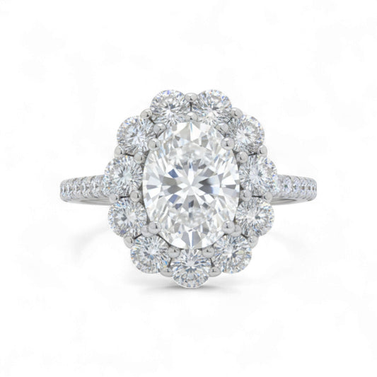 Diamond ring with a central gemstone and halo on a white background