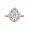 Rose gold ring with a large pear-shaped diamond and smaller diamonds on a white background