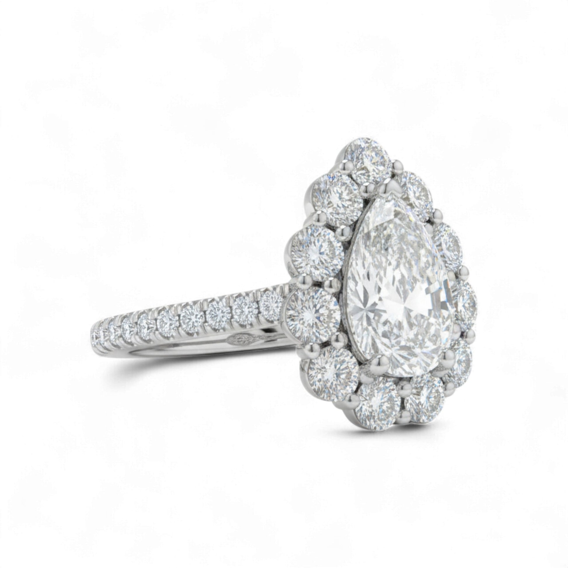 Diamond ring with a pear-shaped center stone on a white background