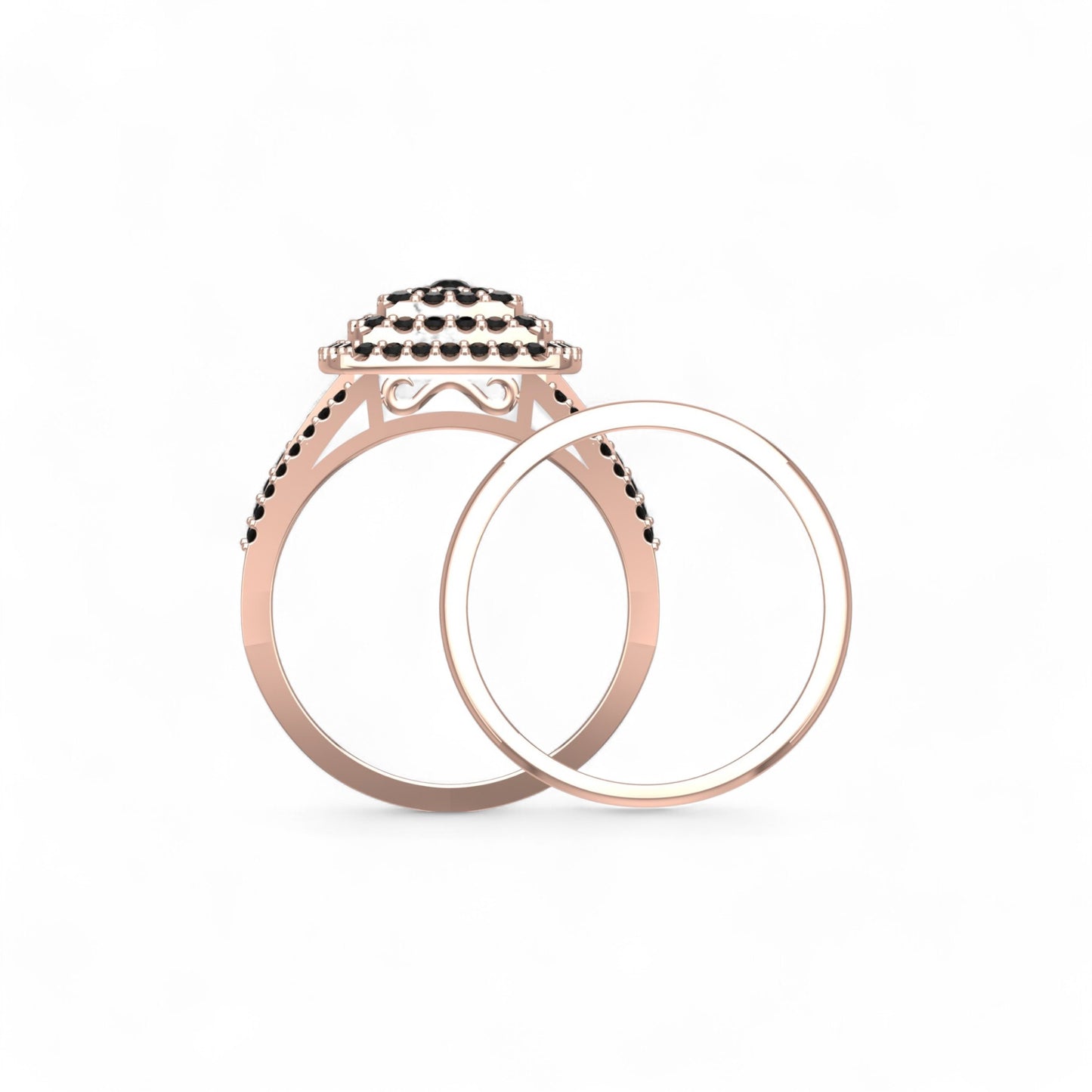 Rose gold ring with black gemstones on a white background