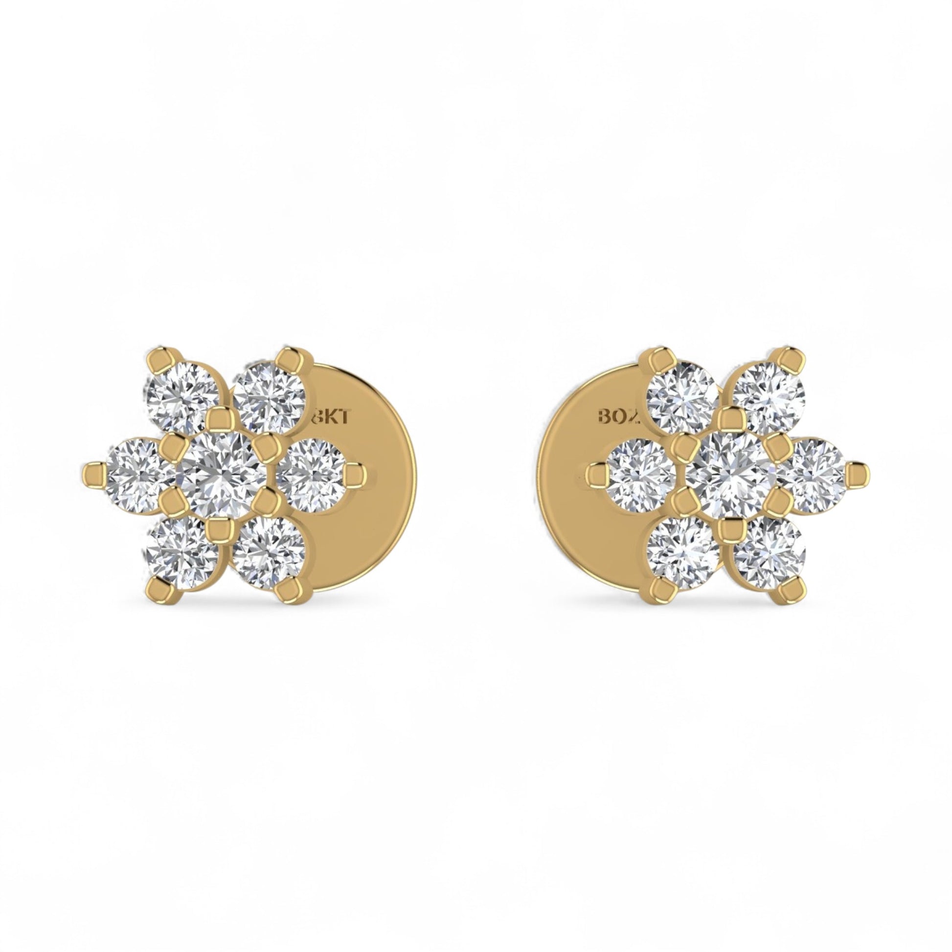 Gold earrings with diamond-like stones on a white background