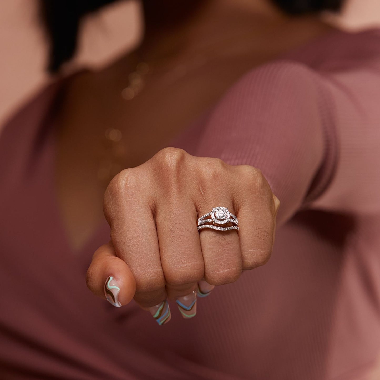Close-up of a hand wearing a ring with a blurred background