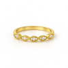 Gold ring with diamond accents on a white background