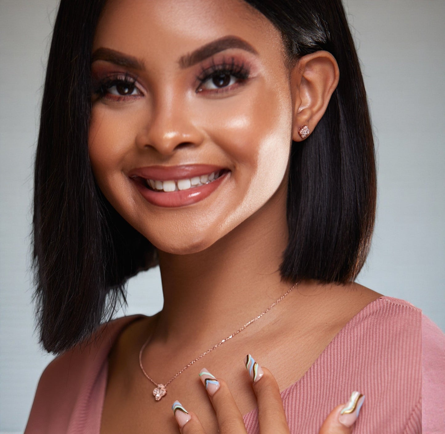 Woman with a close-up of her face showing makeup application on a neutral background