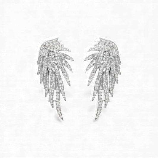 Pair of silver leaf-shaped earrings on a light gray background