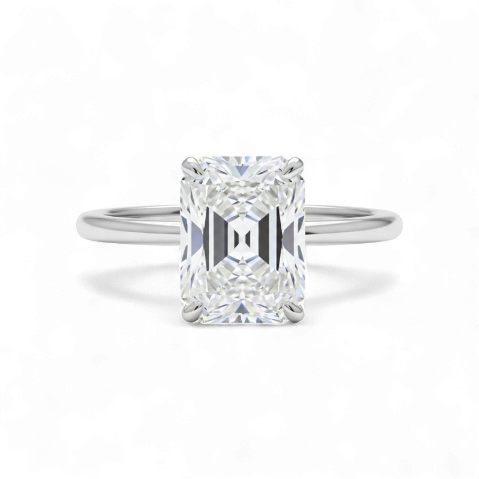Diamond ring with a rectangular cut gemstone on a white background