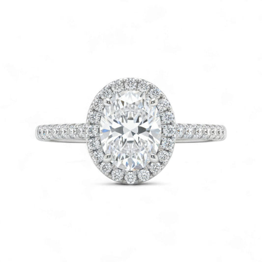 Diamond ring with a halo on a white background