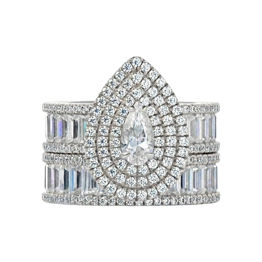 Elegant diamond ring with a central pear-shaped stone and baguette-cut stones on a white background