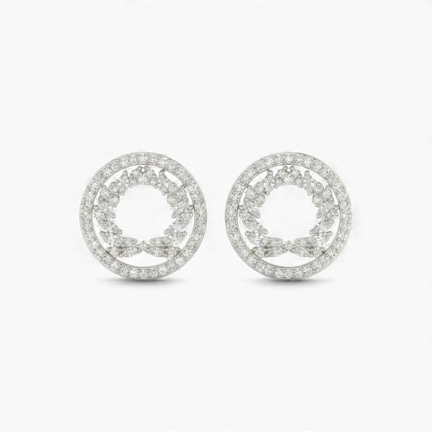 Pair of silver earrings with circular design on a white background