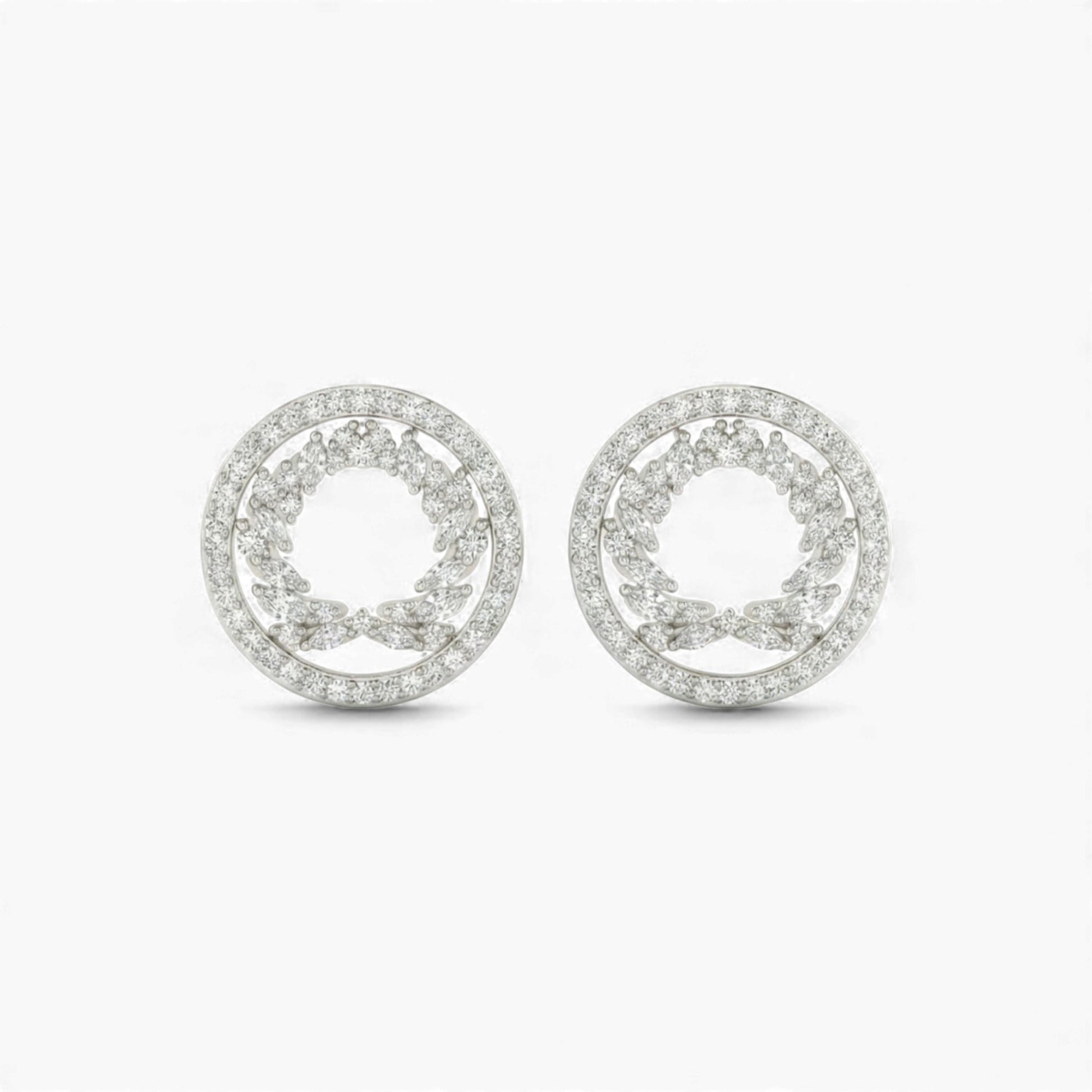 Pair of silver earrings with circular design on a white background