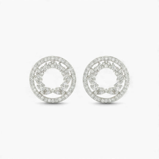 Pair of silver earrings with circular design on a white background