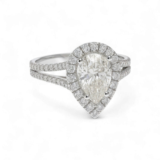 Diamond ring with pear-shaped center stone on a white background