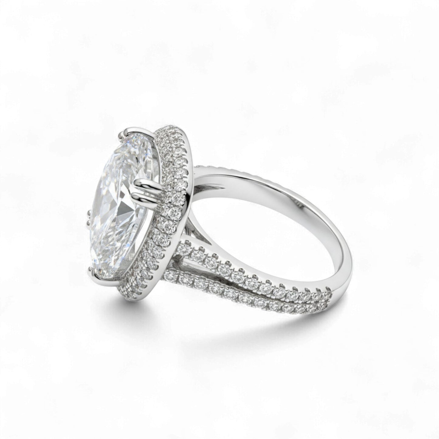 Silver ring with a large central gemstone and smaller stones on the band against a white background