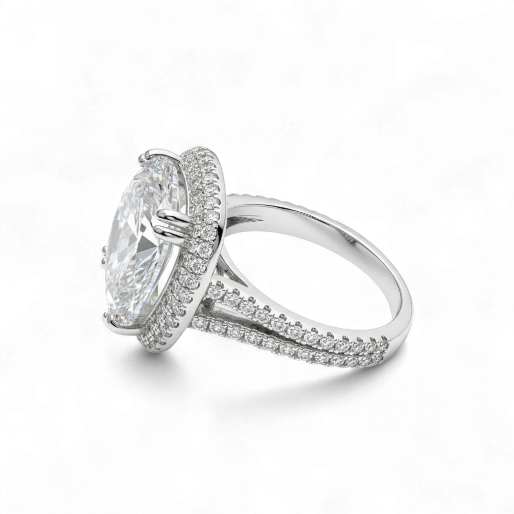 Silver ring with a large central gemstone and smaller stones on the band against a white background