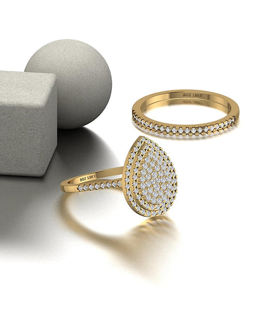 A set of three 18K gold rings, with the central ring featuring a pear-cut natural diamond cluster, surrounded by two smaller rings.