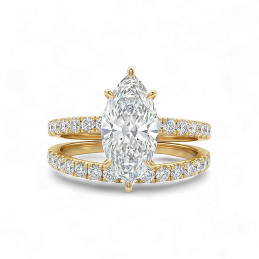 Gold ring with a pear-shaped diamond and smaller diamonds on a white background