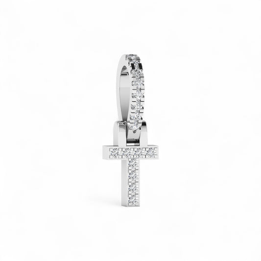 Silver cross-shaped earring with clear stones on a white background