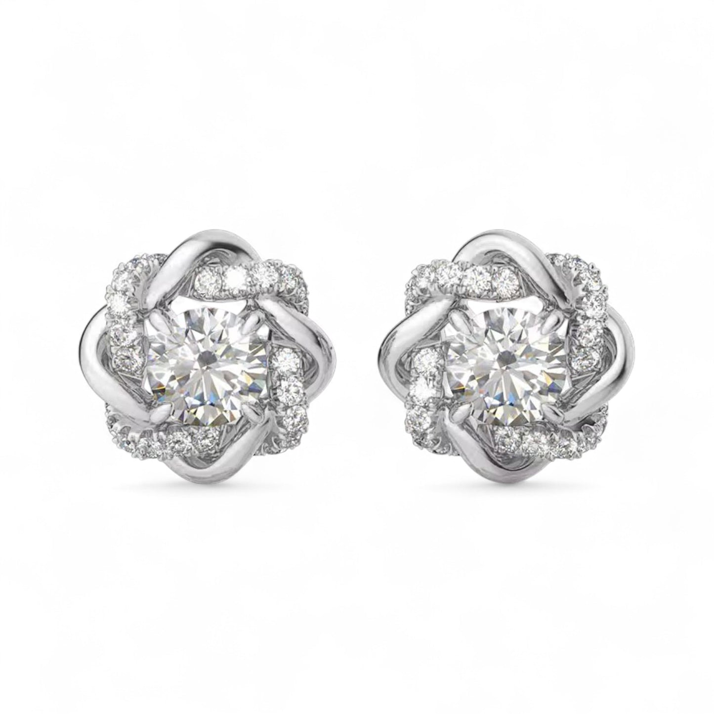 Pair of silver earrings with clear gemstones on a white background