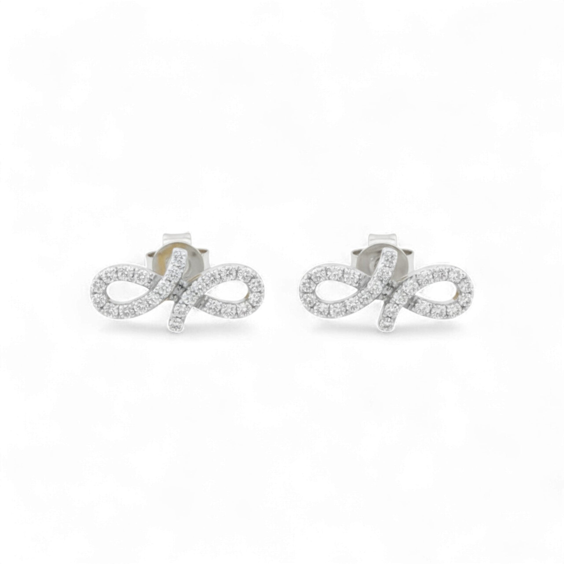 Pair of silver earrings with diamond accents on a white background