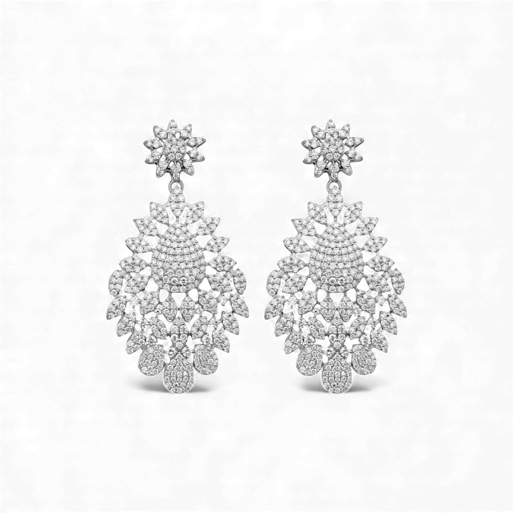 Pair of silver chandelier earrings on a white background