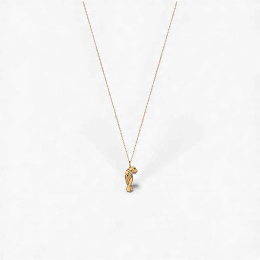 Gold necklace with a small pendant on a white background