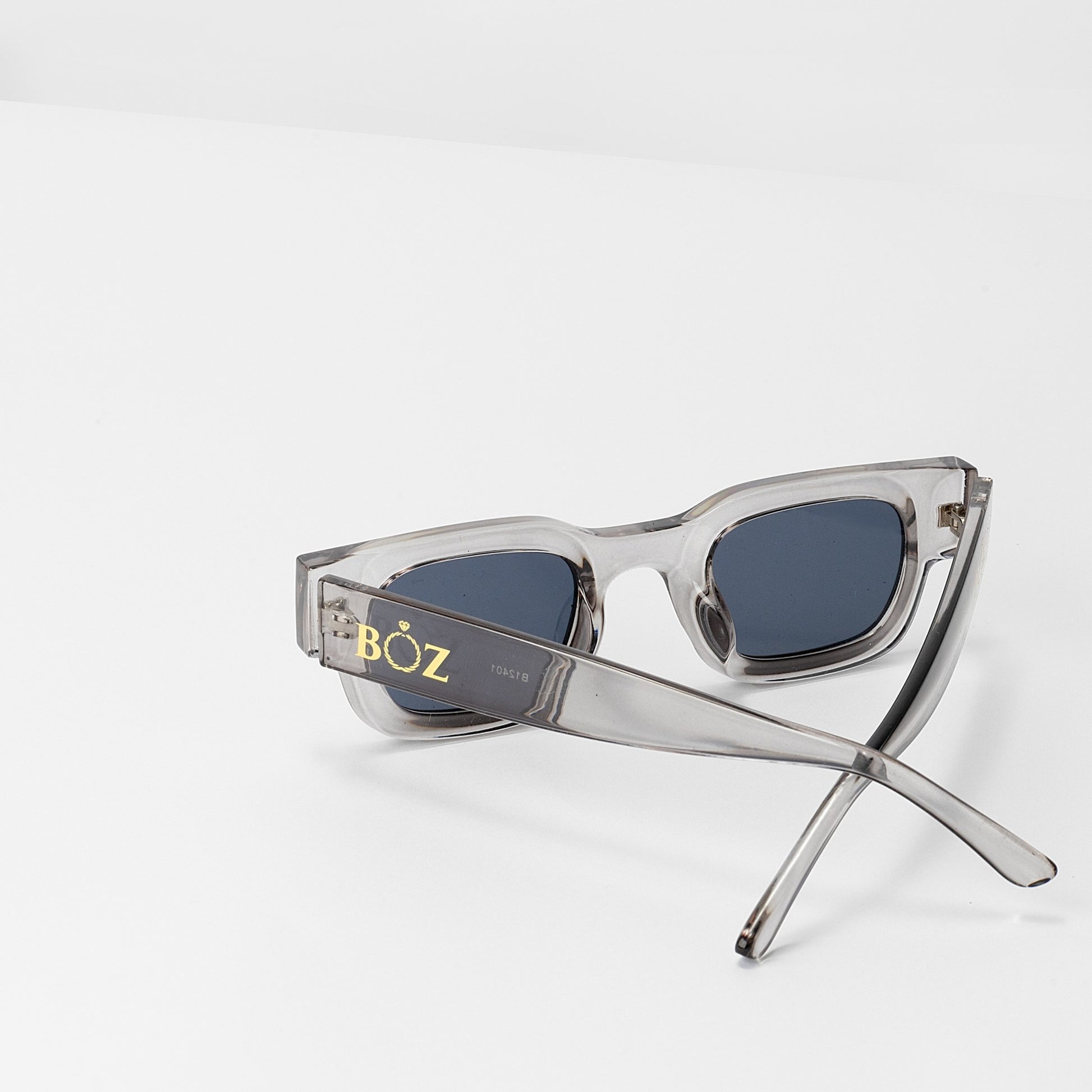 Clear frame sunglasses with blue lenses on a white background, featuring the brand 'BOZ'.