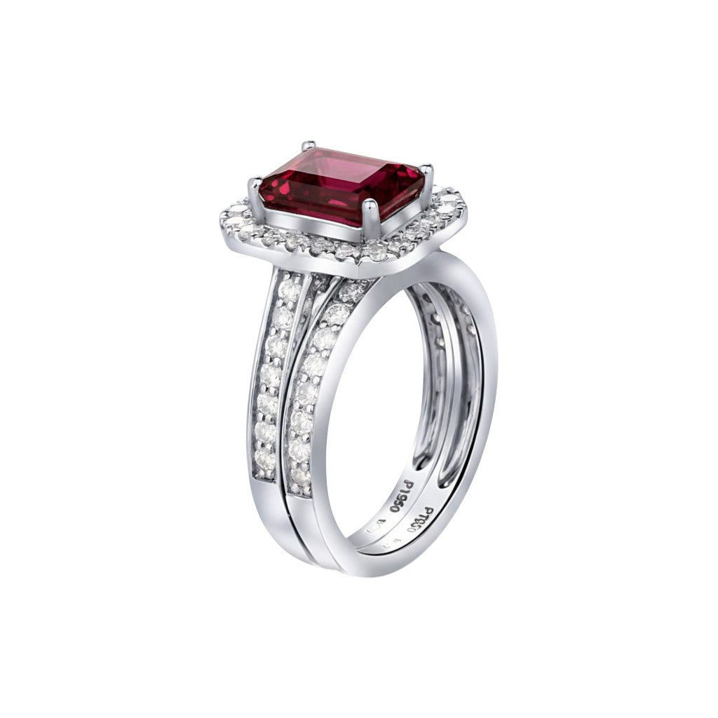 Silver ring with a red gemstone on a white background