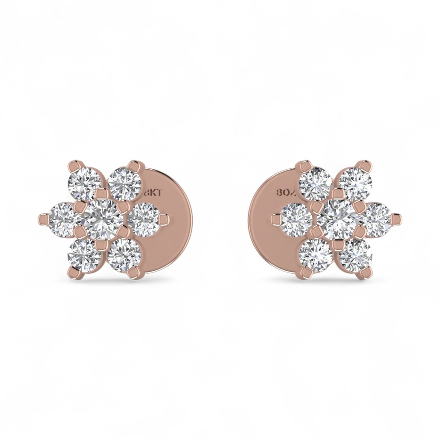 Rose gold earrings with diamond-like stones on a white background