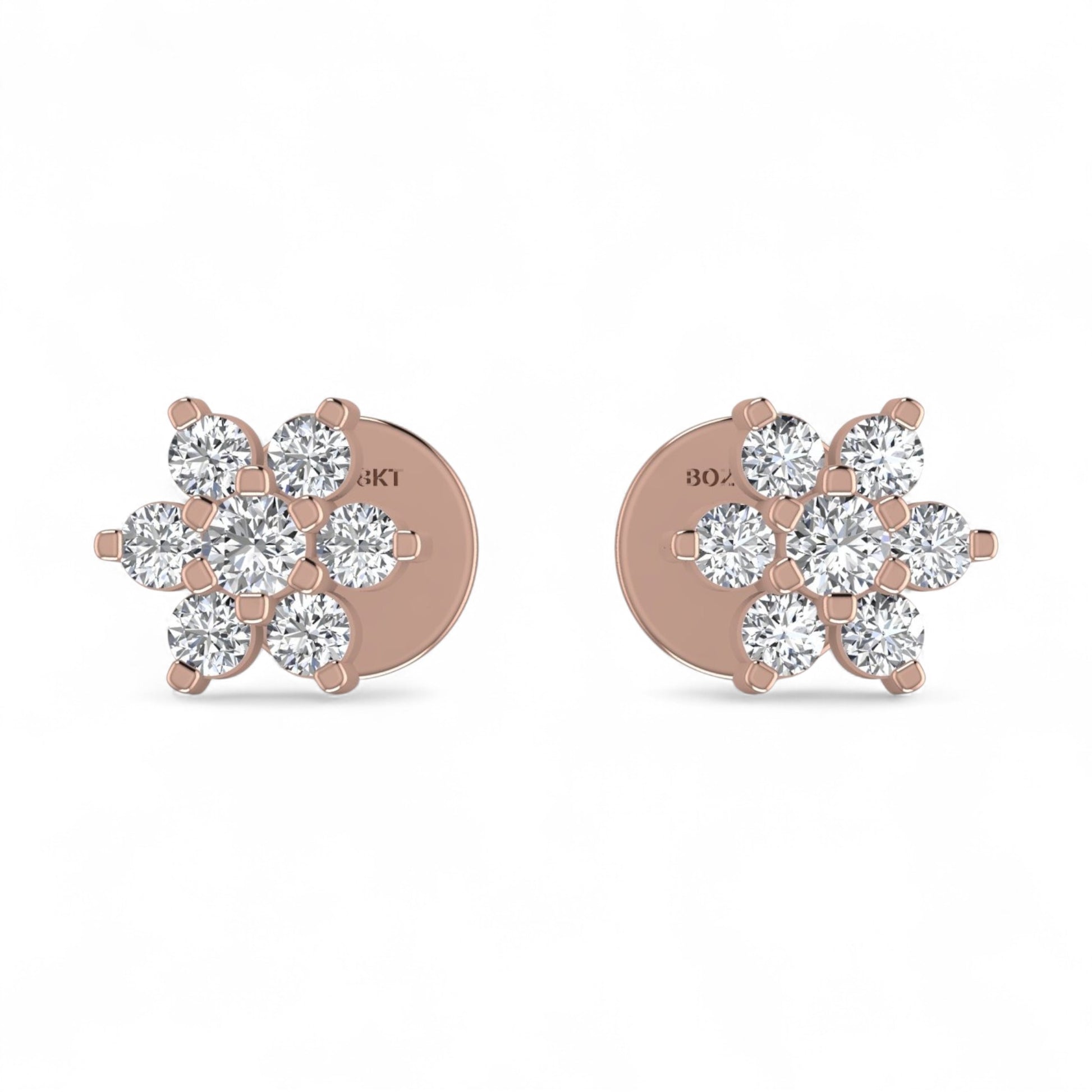 Rose gold earrings with diamond-like stones on a white background