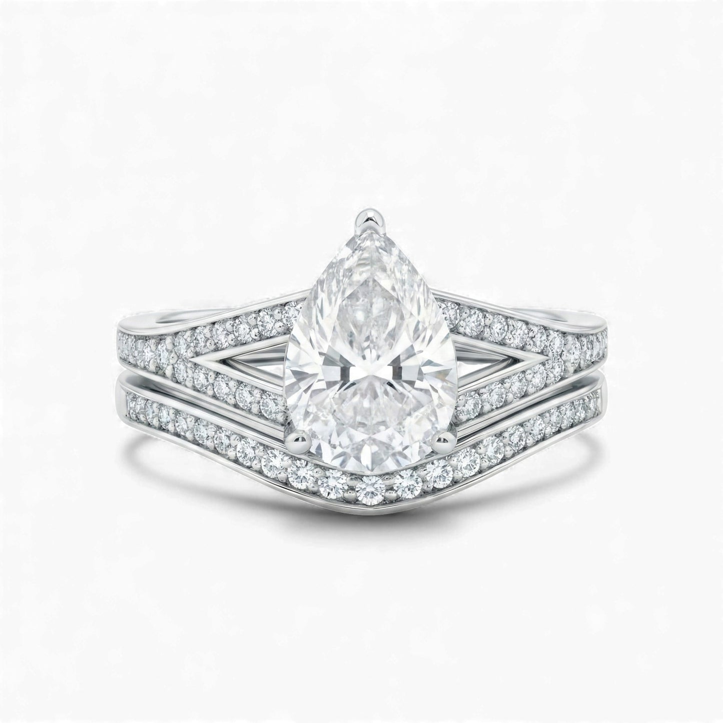 Diamond ring with a pear-shaped center stone on a white background