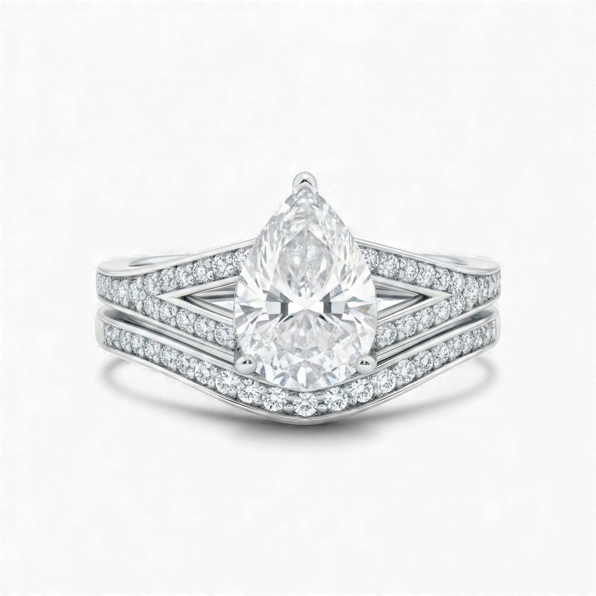 Diamond ring with a pear-shaped center stone on a white background