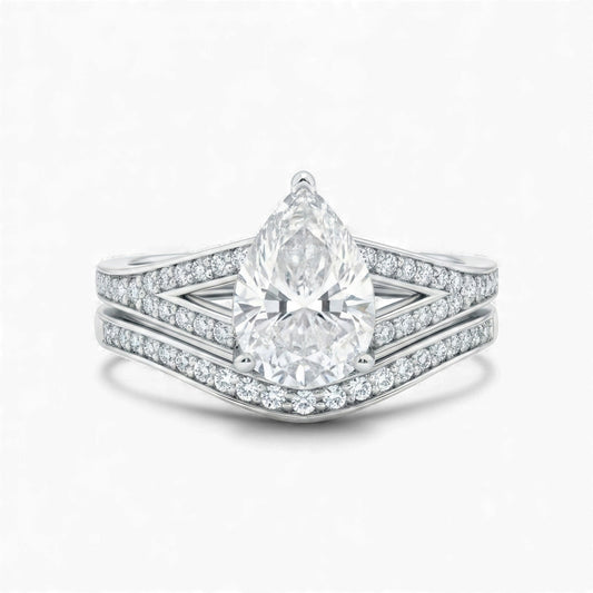 Diamond ring with a pear-shaped center stone on a white background