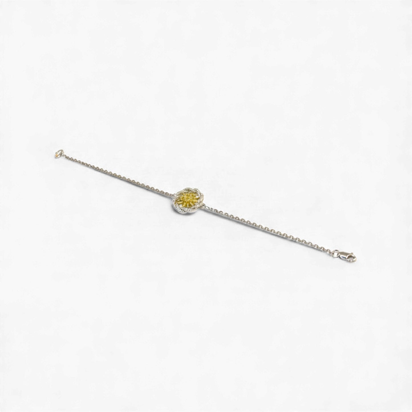 Silver bracelet with a yellow gemstone on a white background