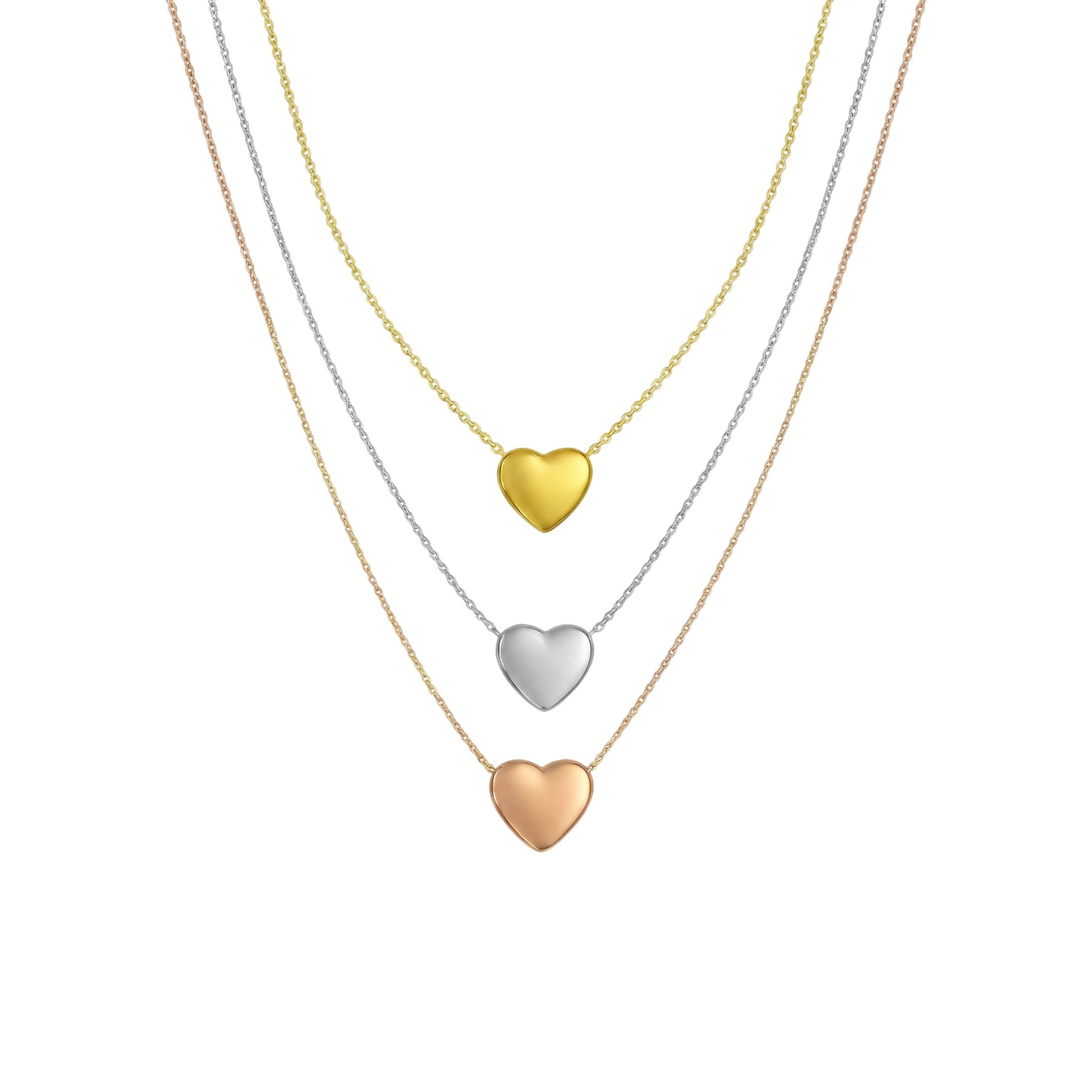 Three heart-shaped pendants on gold necklaces against a white background