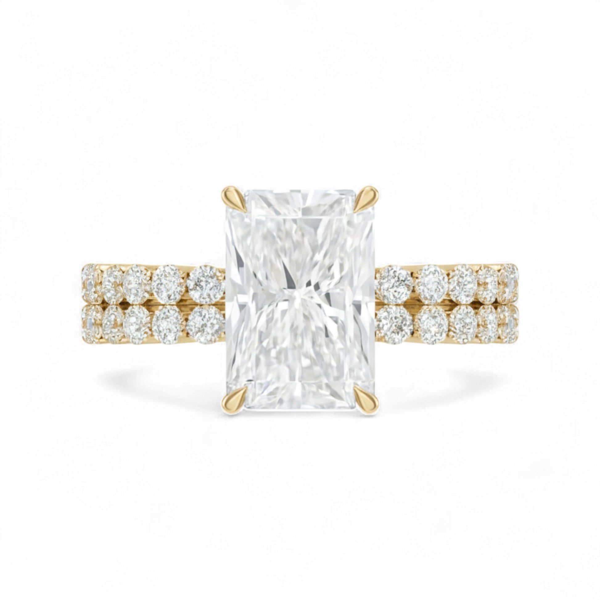 Gold ring with a large diamond and smaller diamonds on the band against a white background