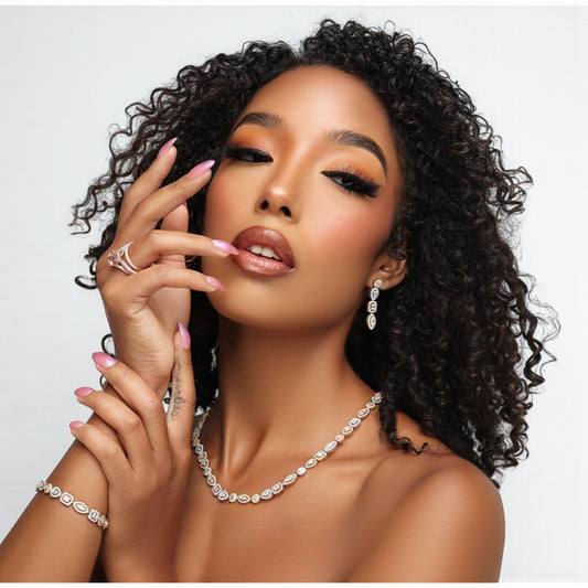 Woman with styled hair wearing jewelry on a plain background