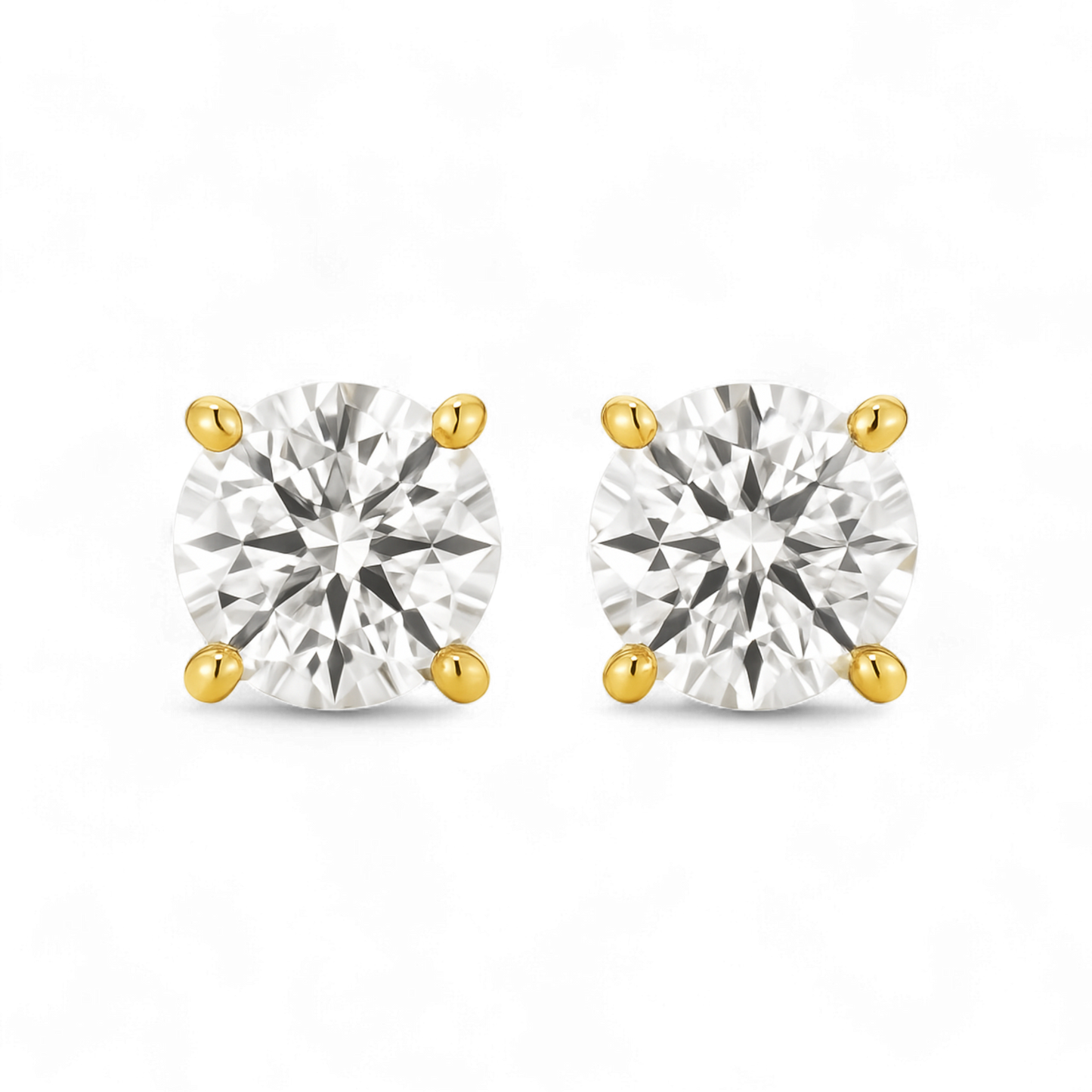 Pair of gold and silver stud earrings on a white background